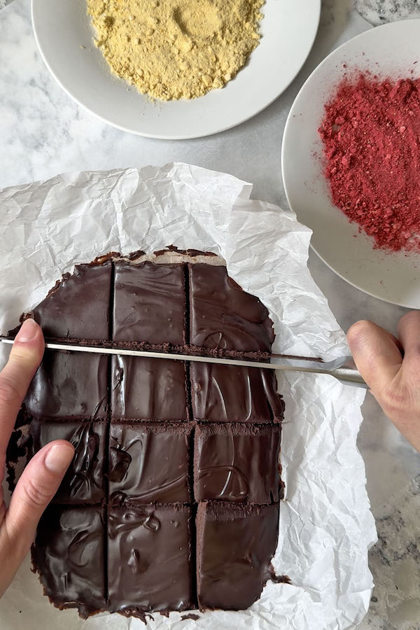 Chilled chocolate truffle mixture cut into squares.