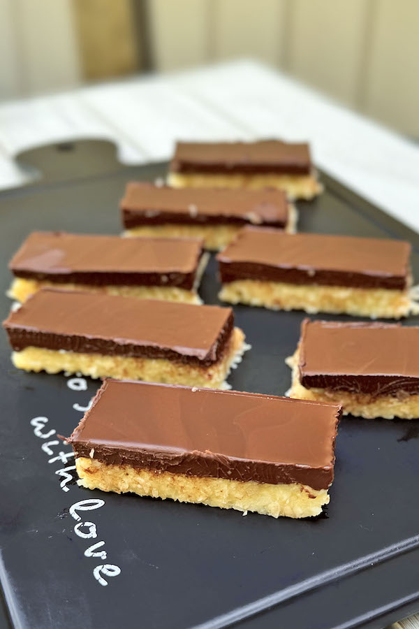 No-bake 2-Layer chocolate coconut bars on a serving board.