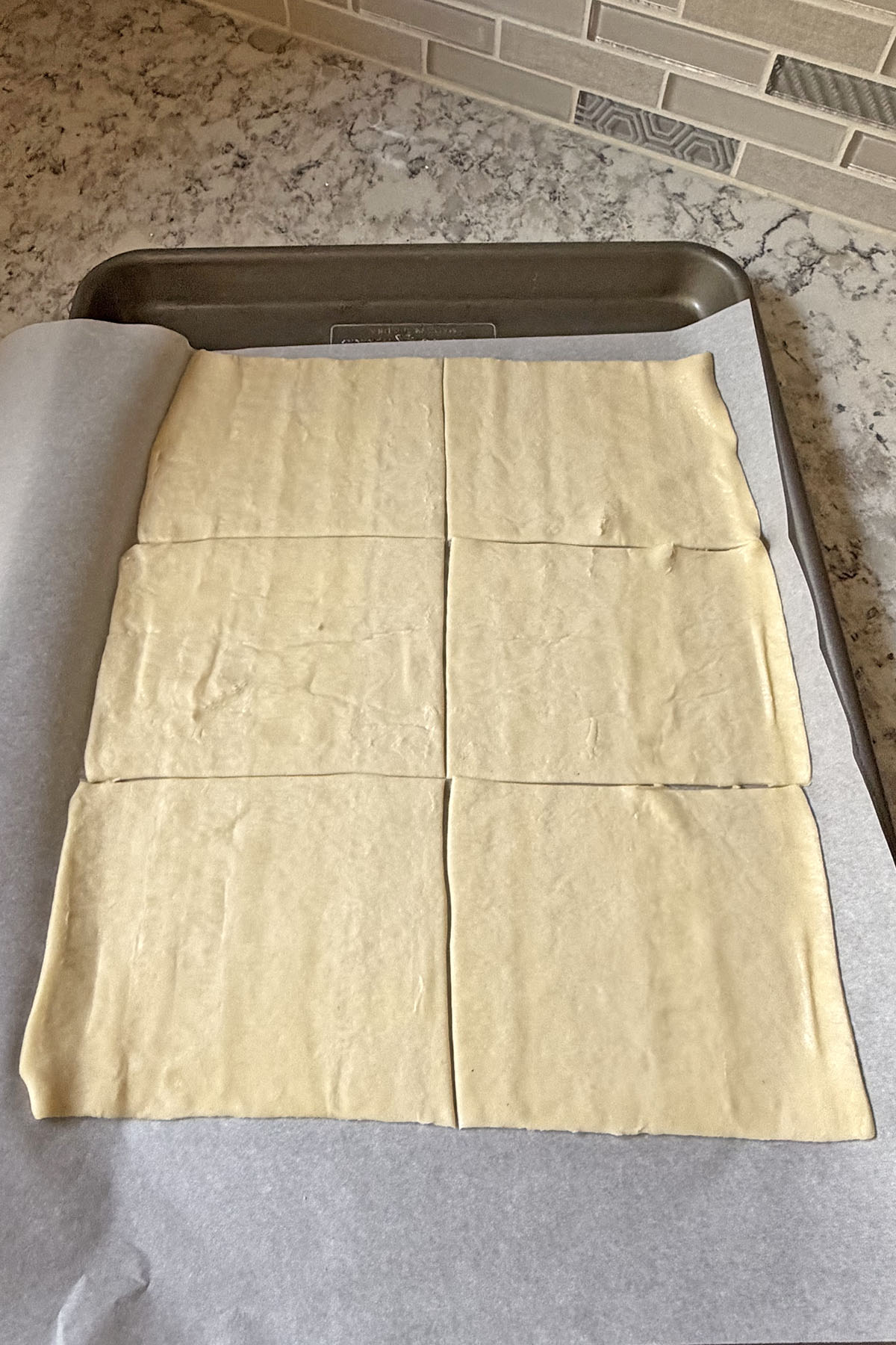 Puff pastry sheet cut in 6 equal squares.