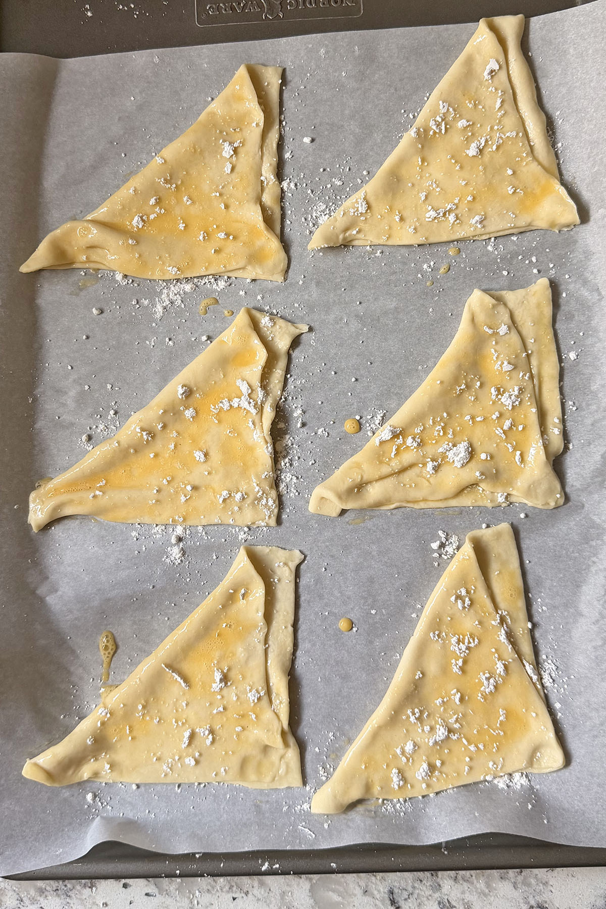 Puff pastry triangles topped with powdered sugar.