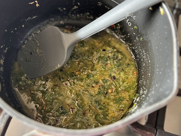 Finishing sauce for the chicken skewers made of ghee, crushed red pepper, garlic, Parmesan and parsley.