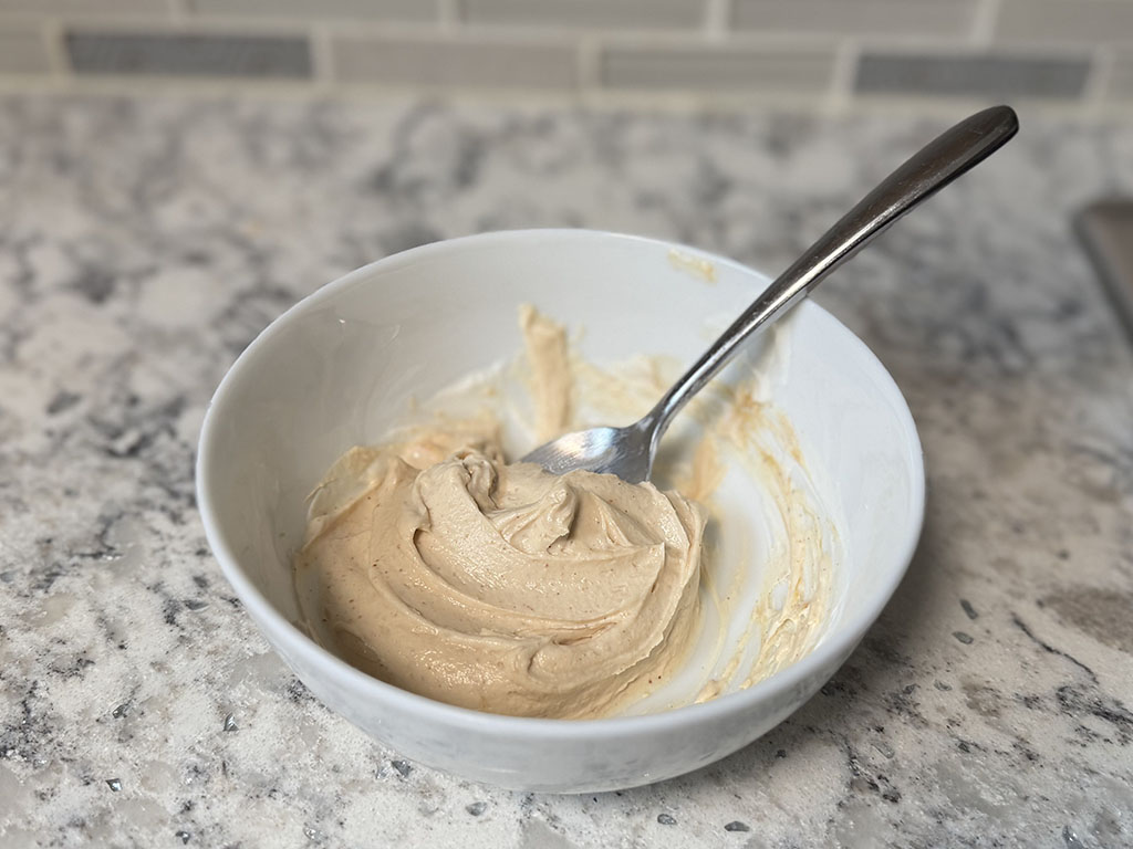 Greek yogurt mixed with peanut butter in a small bowl.