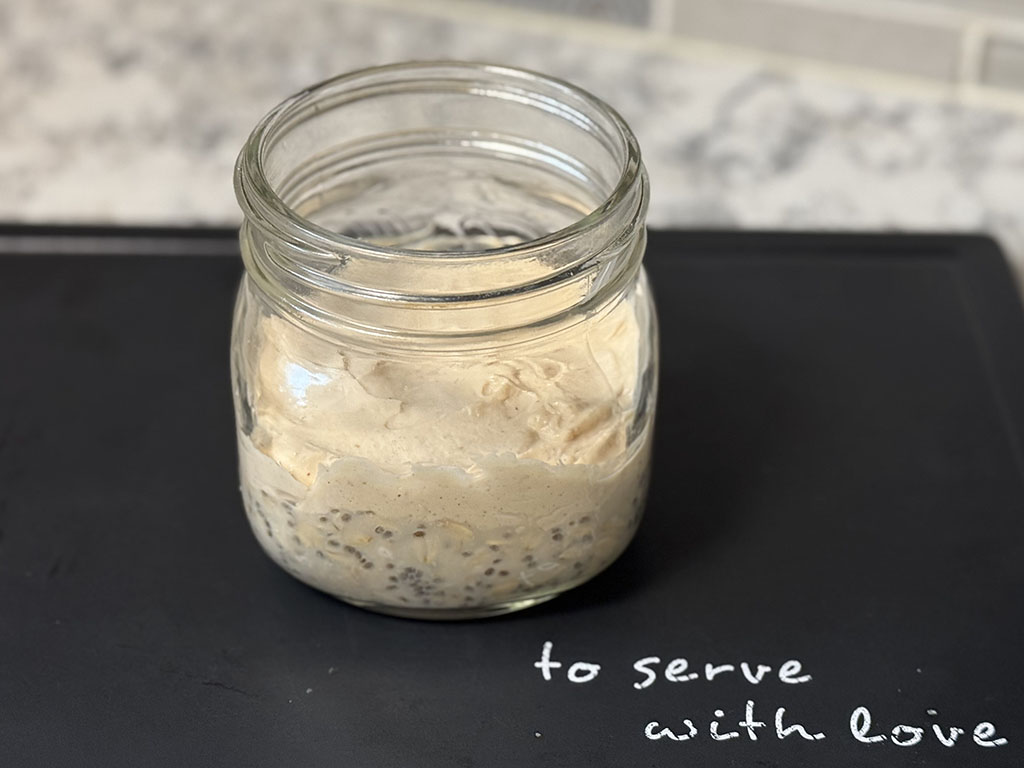 Oat layer with peanut butter yogurt layer on top in a jar.