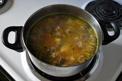 Finished Russian Meatball Soup in a pot on stove top.