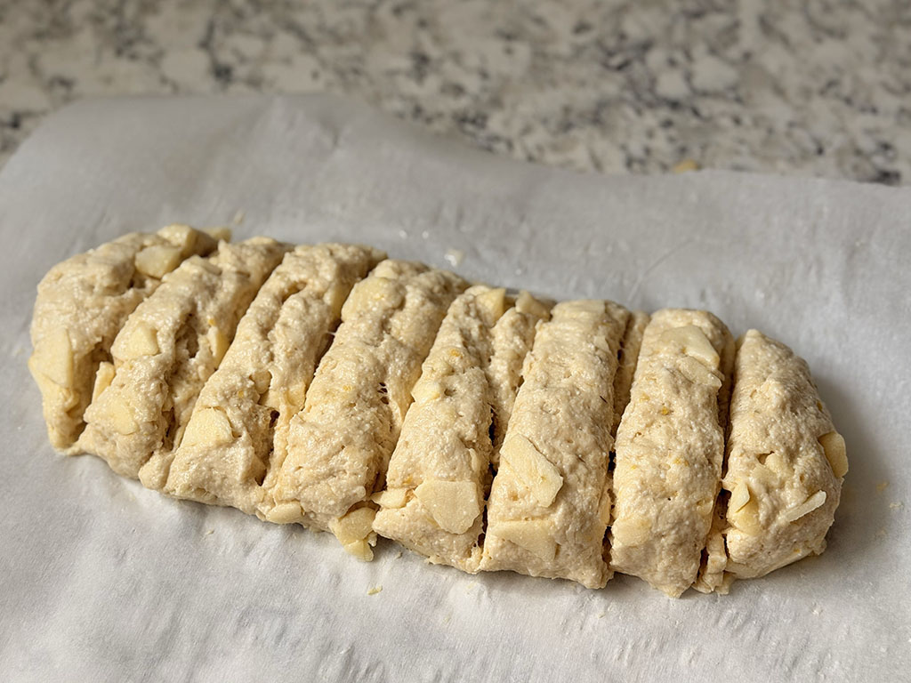Cookie dough shaped into a log and divided into 8 portions.